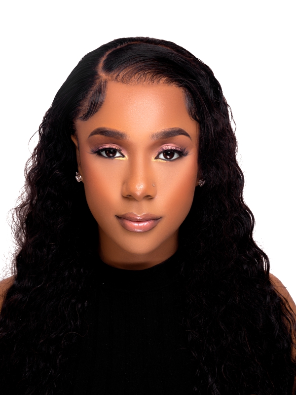 Close Up Portrait Of A Woman With Long Wavy Hair And Soft Glam Makeup Against A White Background.